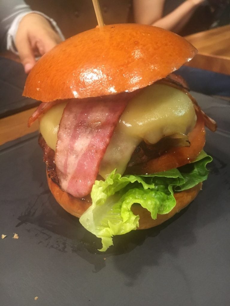 burger with cheese rashers and salad