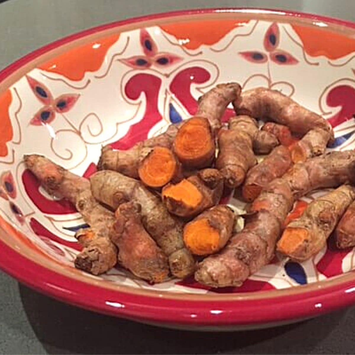 turmeric roots in an orange bowl
