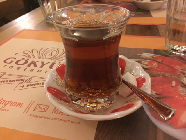 turkish tea on a red and white saucer