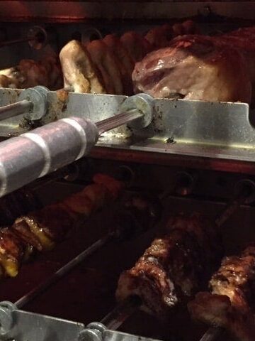 Skewers of meat roasting in the grill.