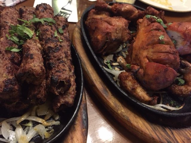 seekh kebabs next to roasted chicken