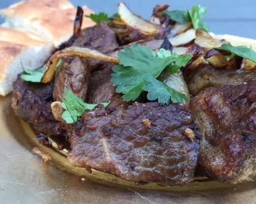 Kashmiri dry lamb with bread and coriander garnish