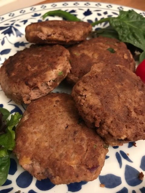 close ups of 4 shami kebabs on a plate