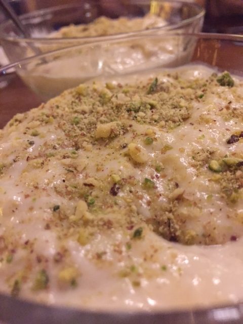 close up of kheer covered in crushed pistachios