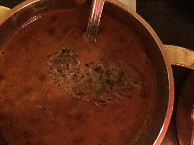 close up of a curry in a copper pot