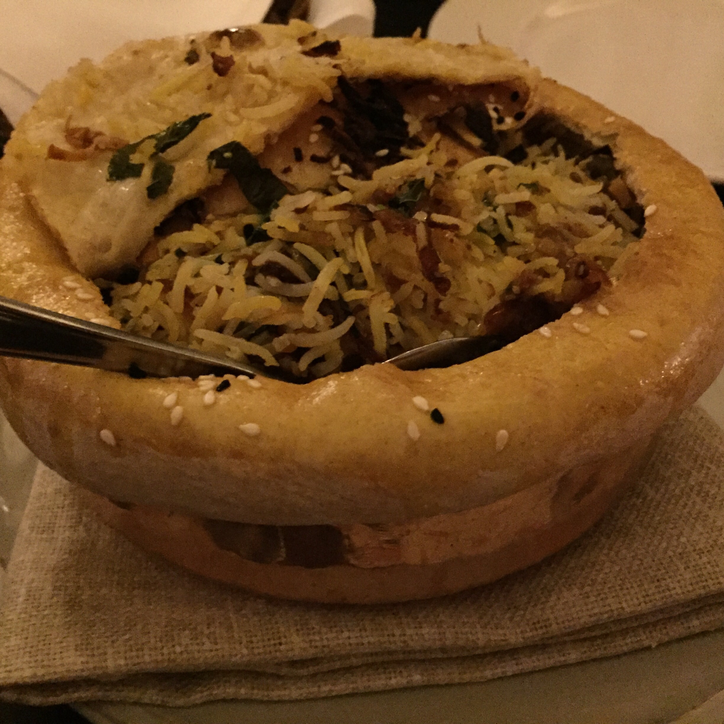 biryani with the pastry cut to the side