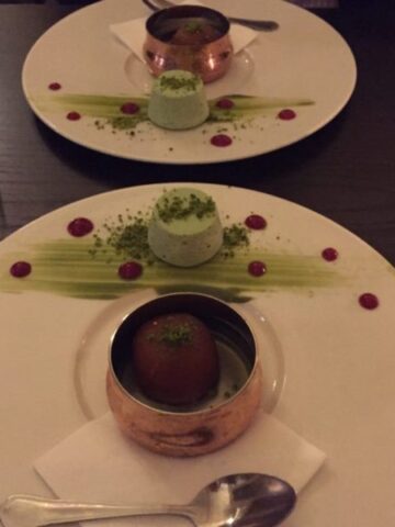 gulab jamun and pistachio kulfi on a white plate