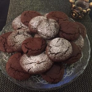 cookies on a plate, some dusted with icing sugar