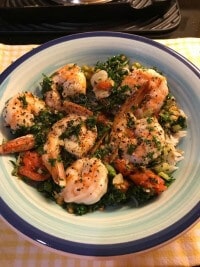 Shrimps on bed of rice in blue bowl