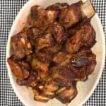 Teriyaki beef ribs in a white oval bowl.