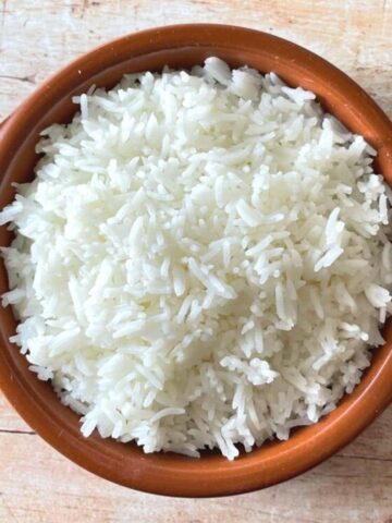Image of plain basmati rice in a brown bowl.