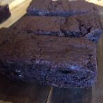 3 rectangular slices of brownies on wooden board