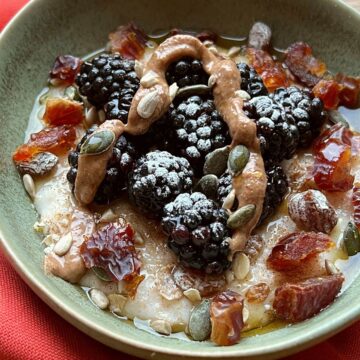 Porridge garnished with fruit, nuts and seeds.