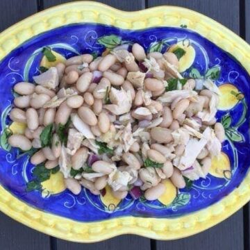 ariel view of tuna bean salad on Italian blue and yellow plate