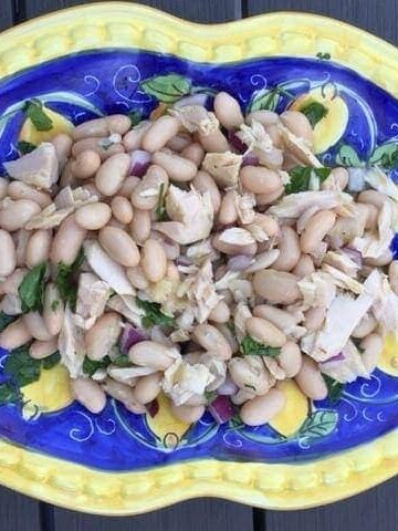 ariel view of tuna bean salad on Italian blue and yellow plate