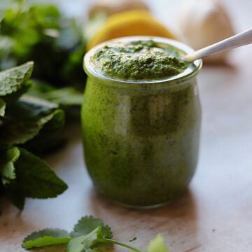 Image of green chutney in small glass jar.