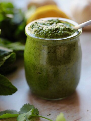 Image of green chutney in small glass jar.