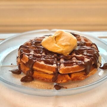 Image of two waffles covered in Nutella and a scoop of ice cream.