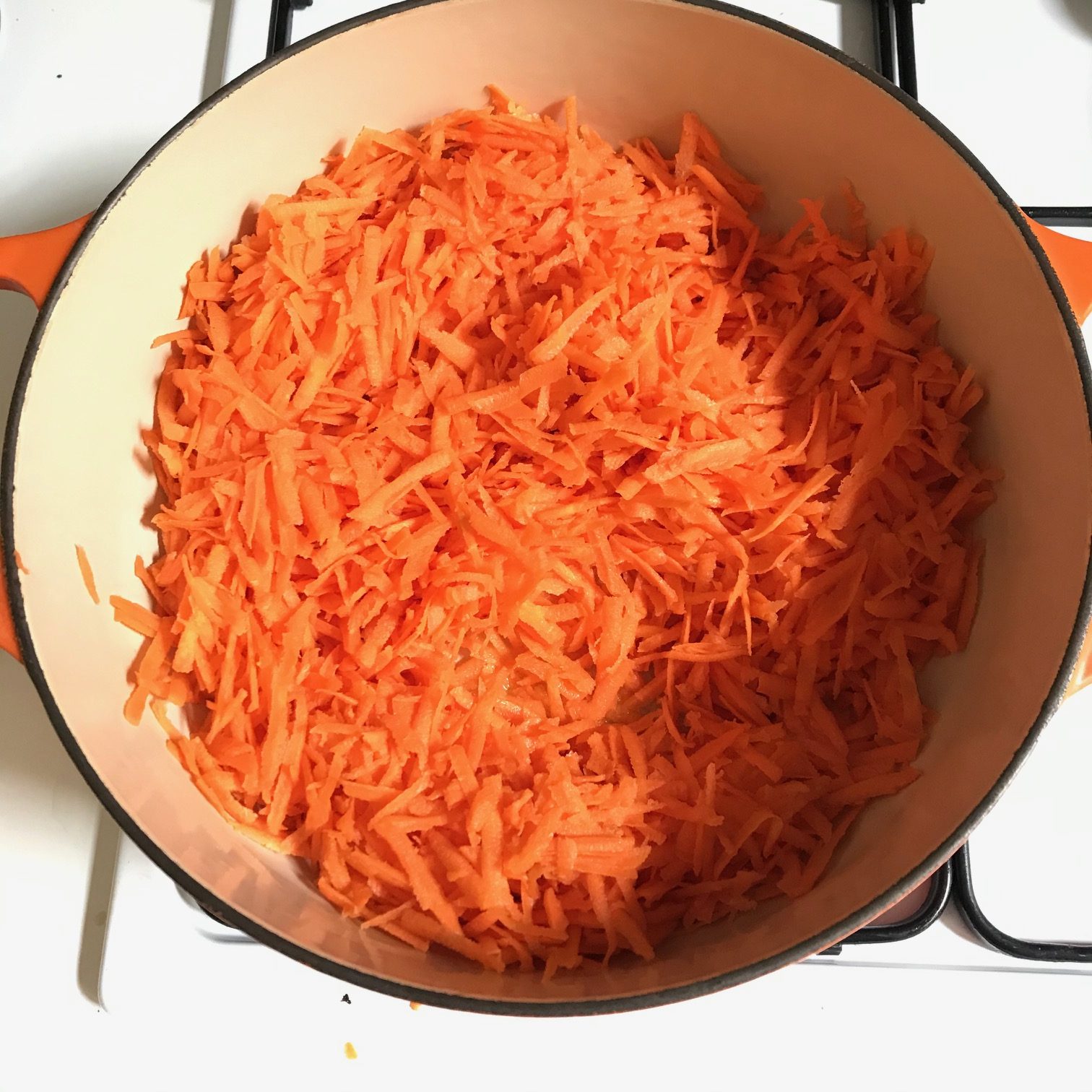 arial view of grated carrots in saucepan on hob