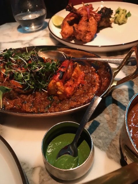 Grilled tiger prawns in sauce on plate 