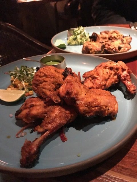 4 pieces of Tandoori chicken on a blue plate