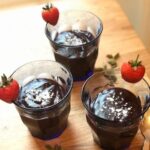 3 glasses on pudding on wooden counter