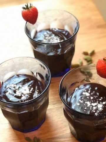 3 glasses on pudding on wooden counter