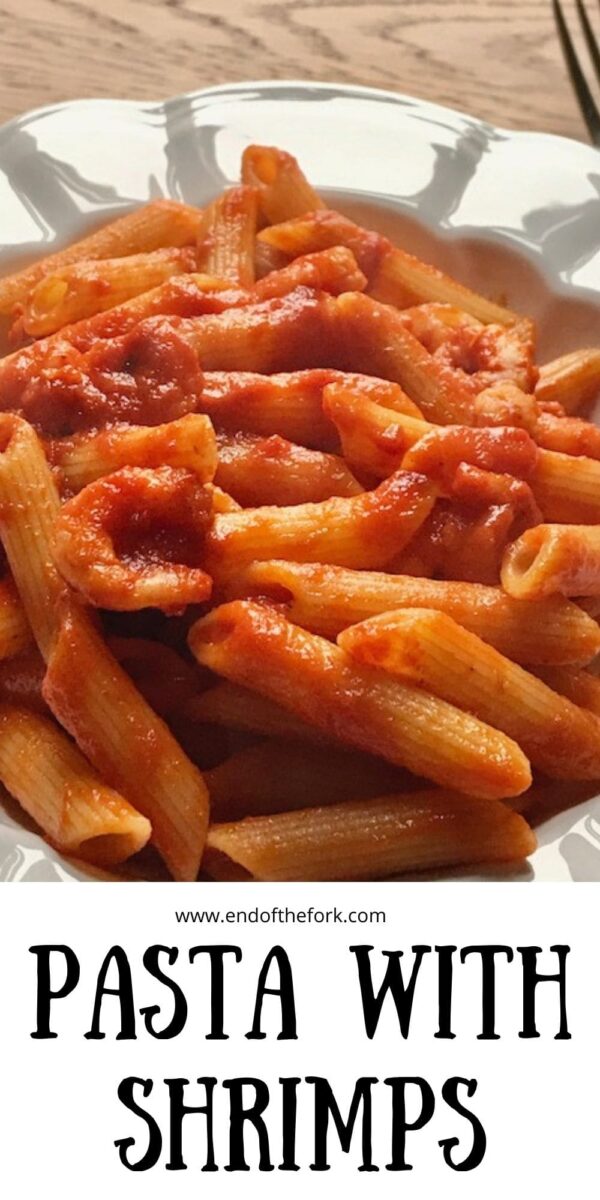 Pin image of pasta with shrimps in tomato sauce in white bowl.