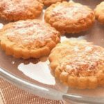 Round shortbread cookies on a glass dish