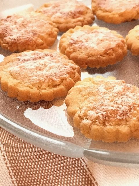 Round shortbread cookies on a glass dish