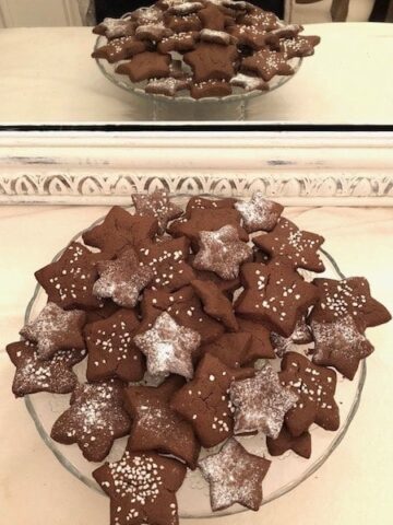 chocolate cookies shaped as stars on a plate