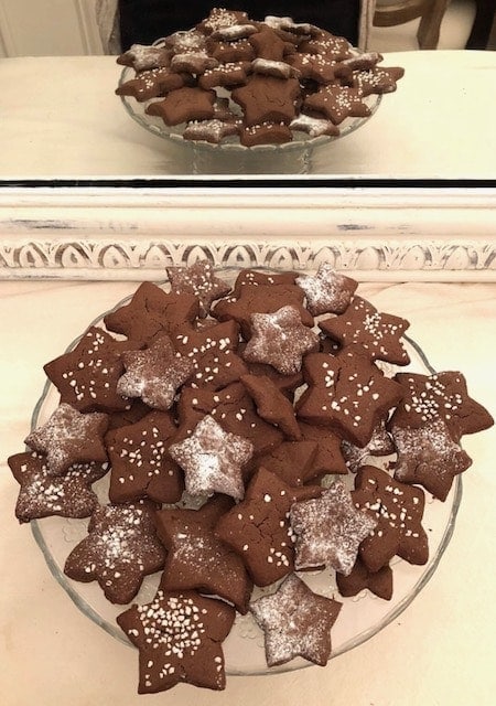 chocolate cookies shaped as stars on a plate