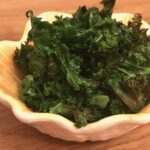 Baked kale in a small yellow bowl