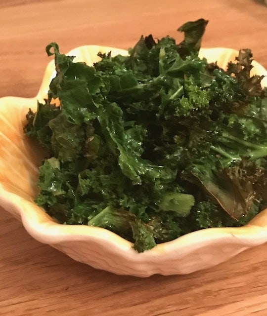 Baked kale in a small yellow bowl