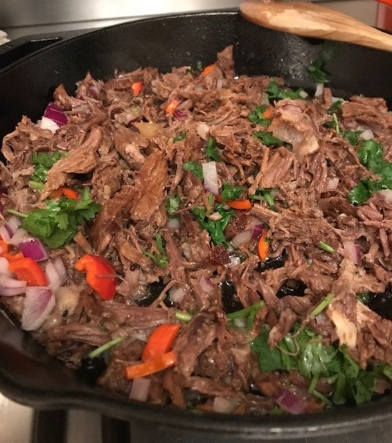 shredded beef, red chilli & fresh coriander in a skillet