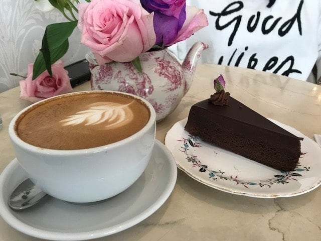 coffee latte and slice of flourless chocolate cake