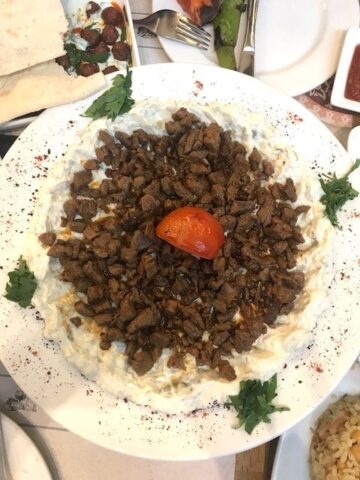 A large portion of ali Nazik on a white plate