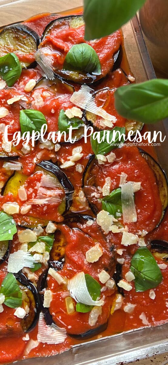 Pin image of eggplant parmesan with fresh basil.
