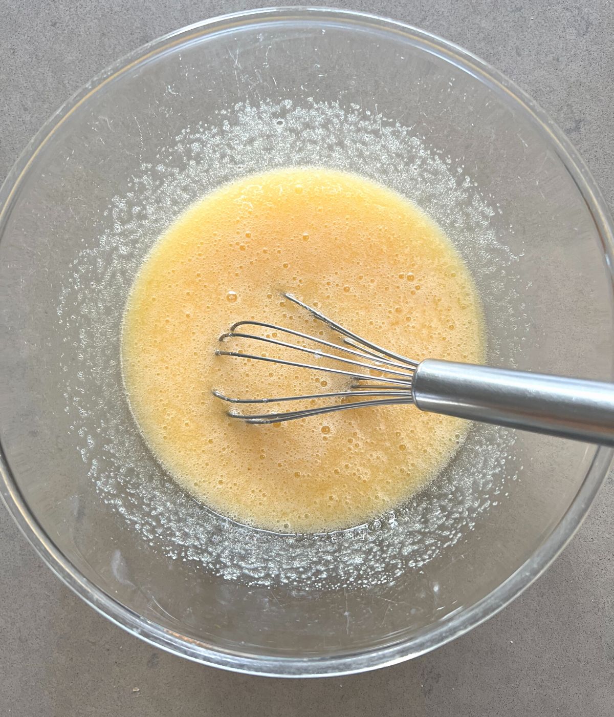 Eggs and butter mixed in bowl.