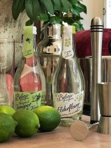 small bottles of Light elderflower presse and jiniper & tonic, with limes