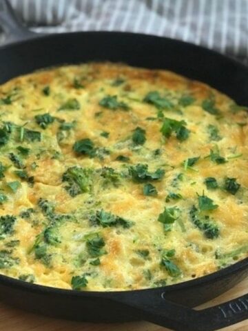 Broccoli potato frittata in iron skillet.