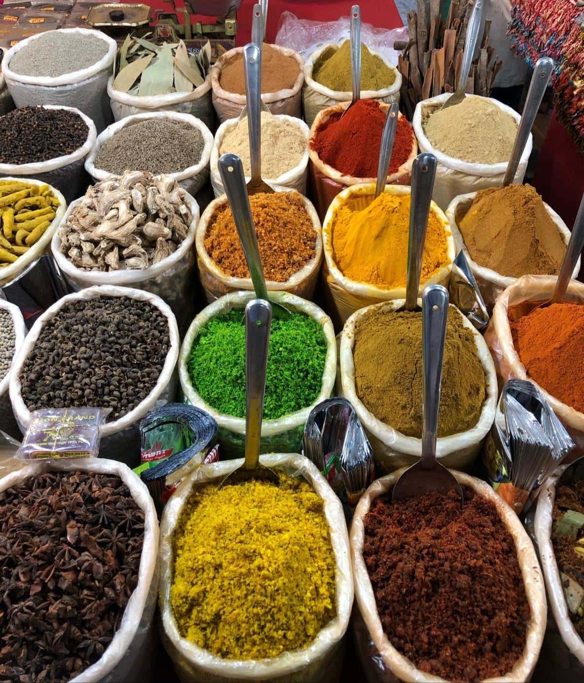 open bags of spices displayed at an Indian market