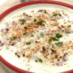 Raita with garnishing in a bowl.