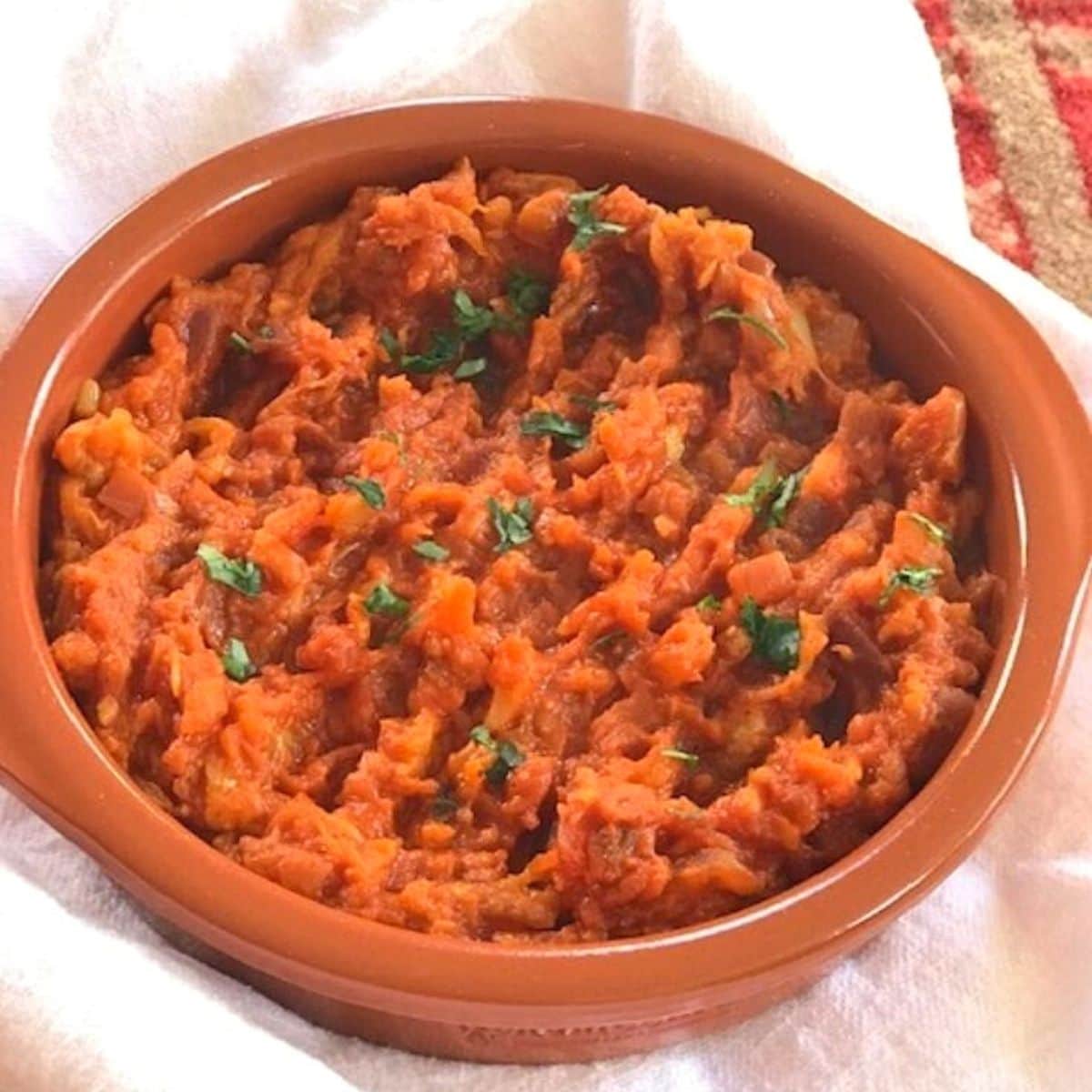 Baingan bharta in a shallow terracotta dish.