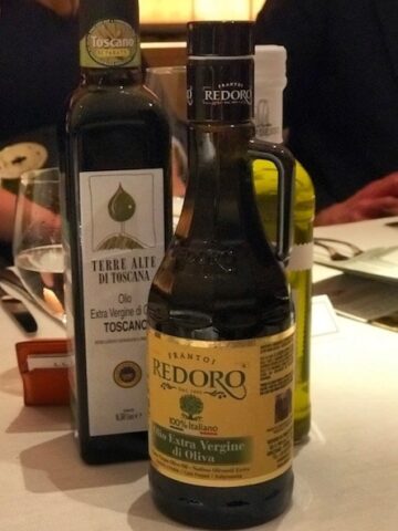 three bottles of olive oil on the dining table