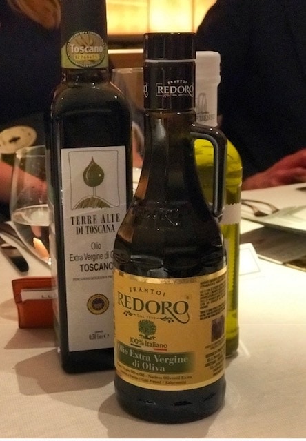 three bottles of olive oil on the dining table