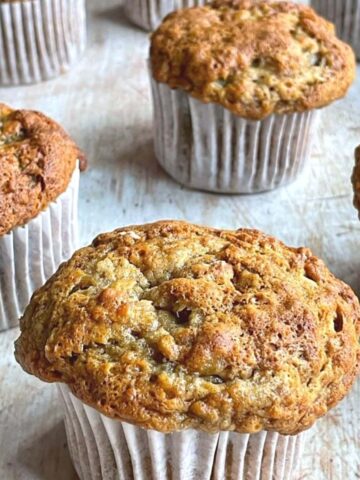 Banana muffins on wooden counter.