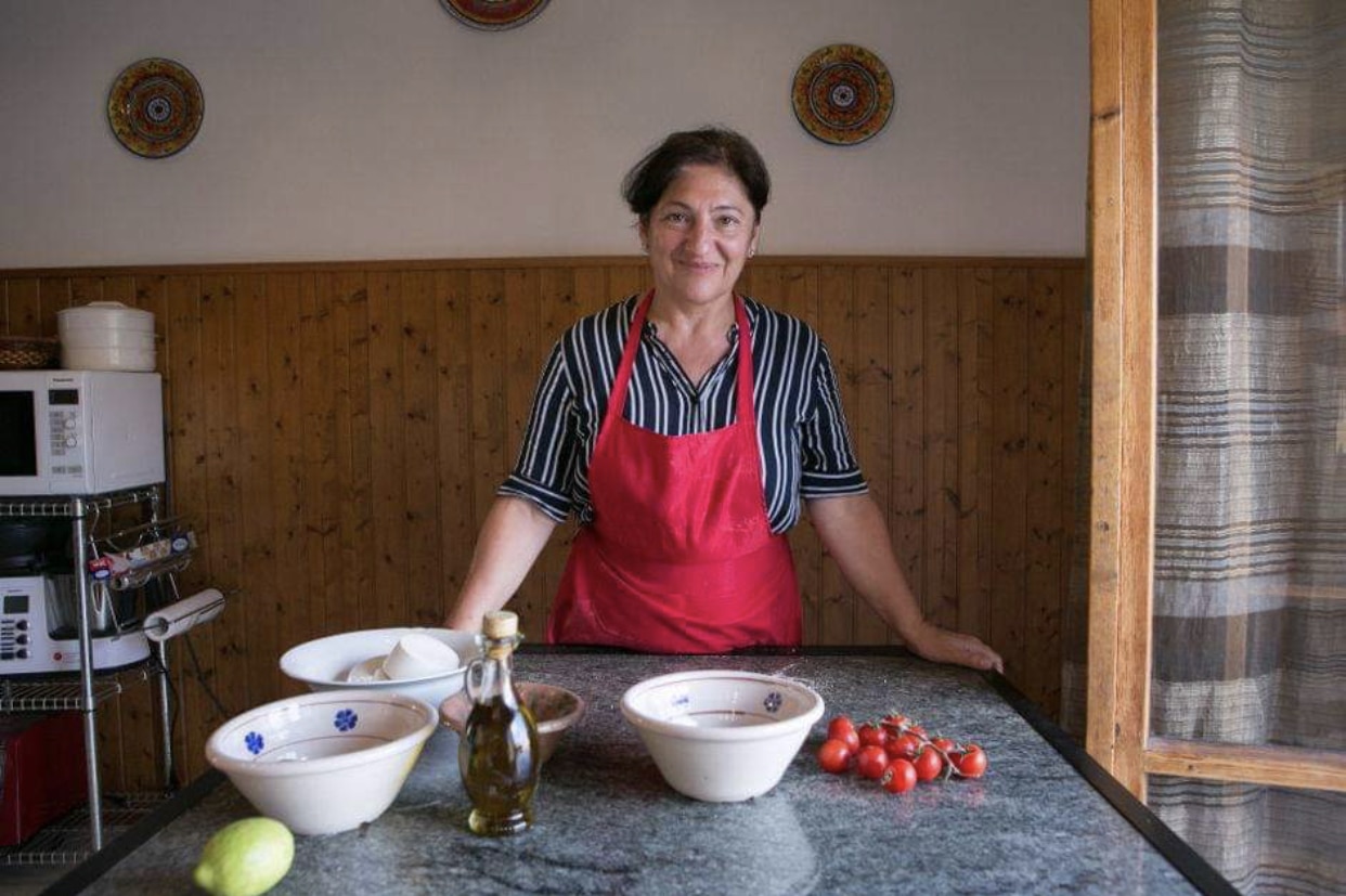 Patrizia behind a work counter with mixing bowls