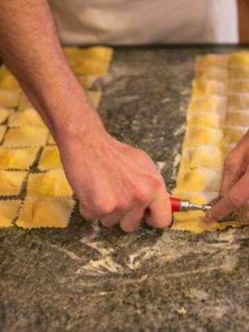 view of hands cutting ravioli