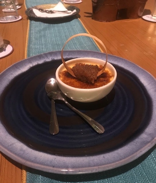 small bowl with creme brulee on a blue plate